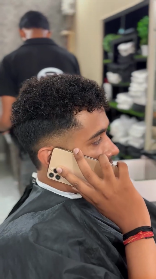 Curly Hair textured top with high skin fade and clean lineup – modern men’s haircut by CXI Hair Salon Palwal, best men haircut near me Haryana