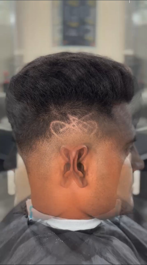 Motorbike hair design with mid to high skin fade – sharp razor artwork above ear – CXI Hair Salon Palwal, modern men haircut Haryana. Best hair Salon in palwal